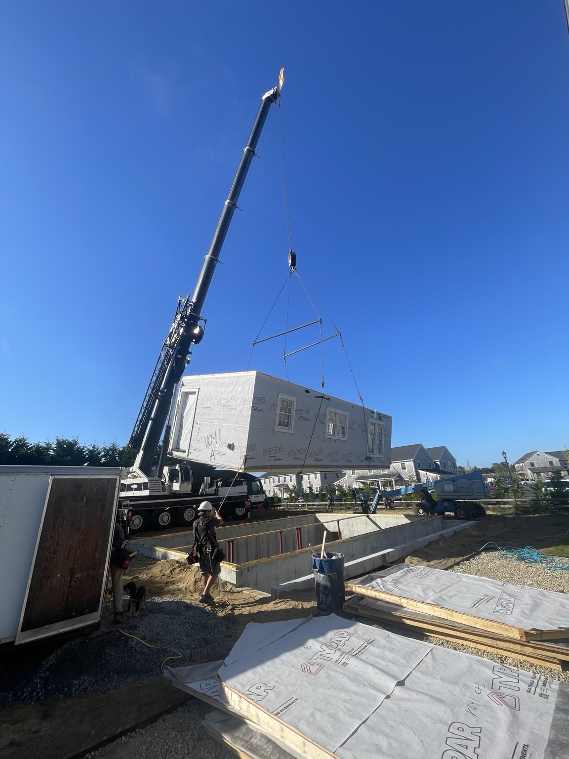 Modular home section being installed by crane